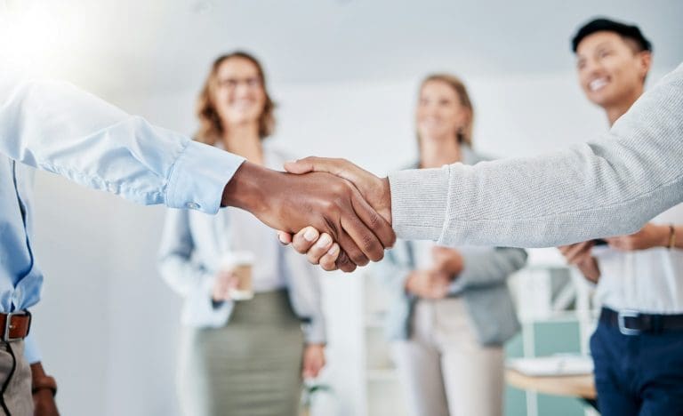 Closeup, business people and handshake for partnership, collaboration and achievement with group pr