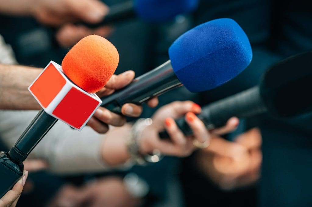 News reporters interviewing a politician.