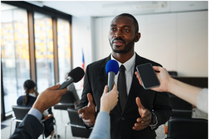 A person being interviewed with multiple microphones